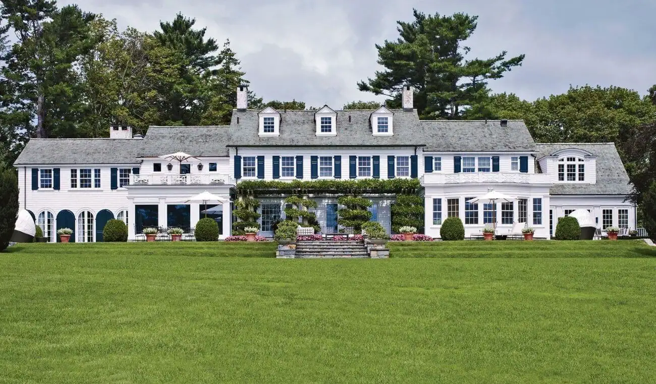 Elegant large mansion with lush gardens, pool, and classic architecture for premium property listing.
