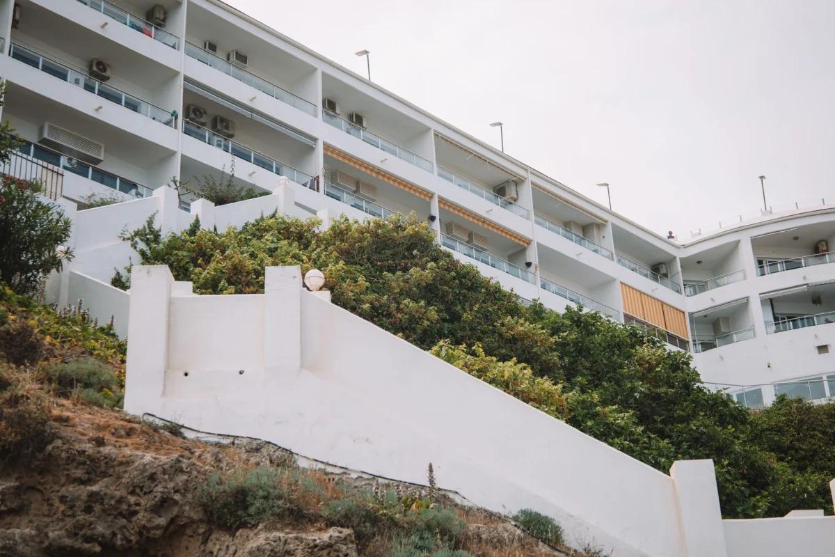 Low angle view of a modern apartment building with white walls in Málaga, Spain.