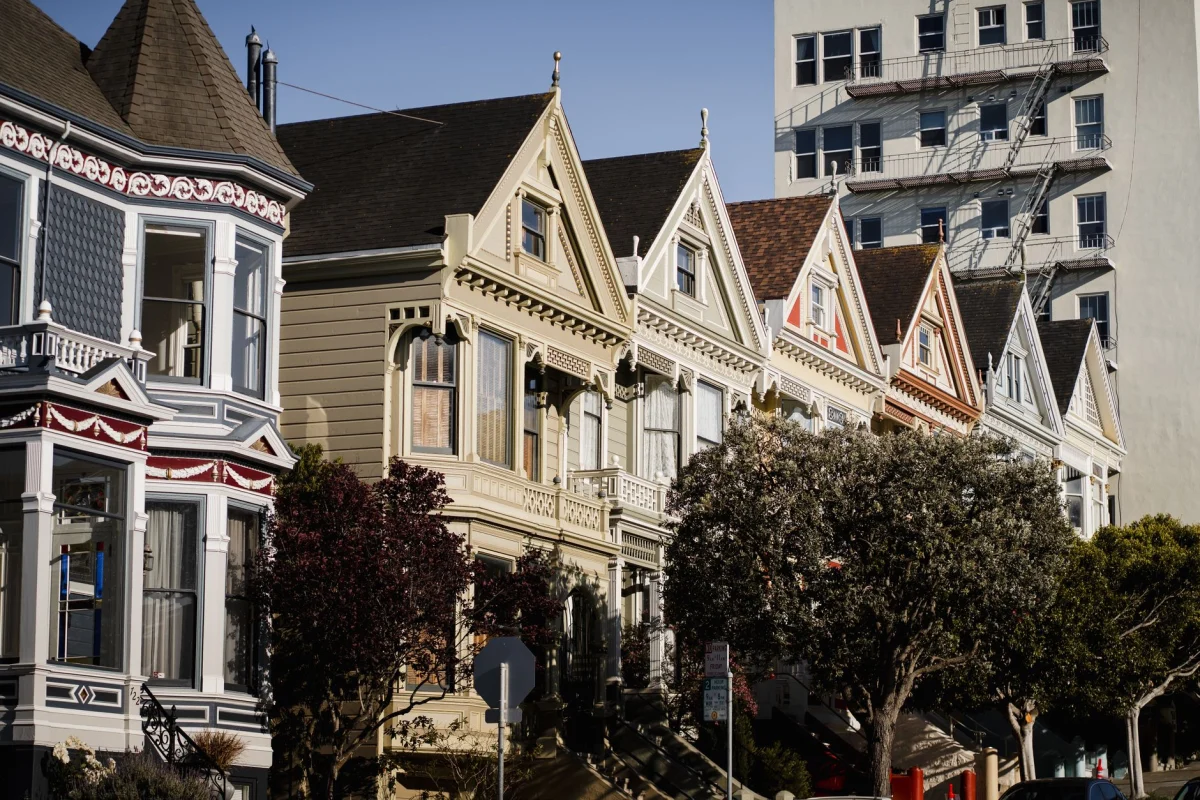 Charming Painted Ladies houses under clear skies in San Francisco, California.